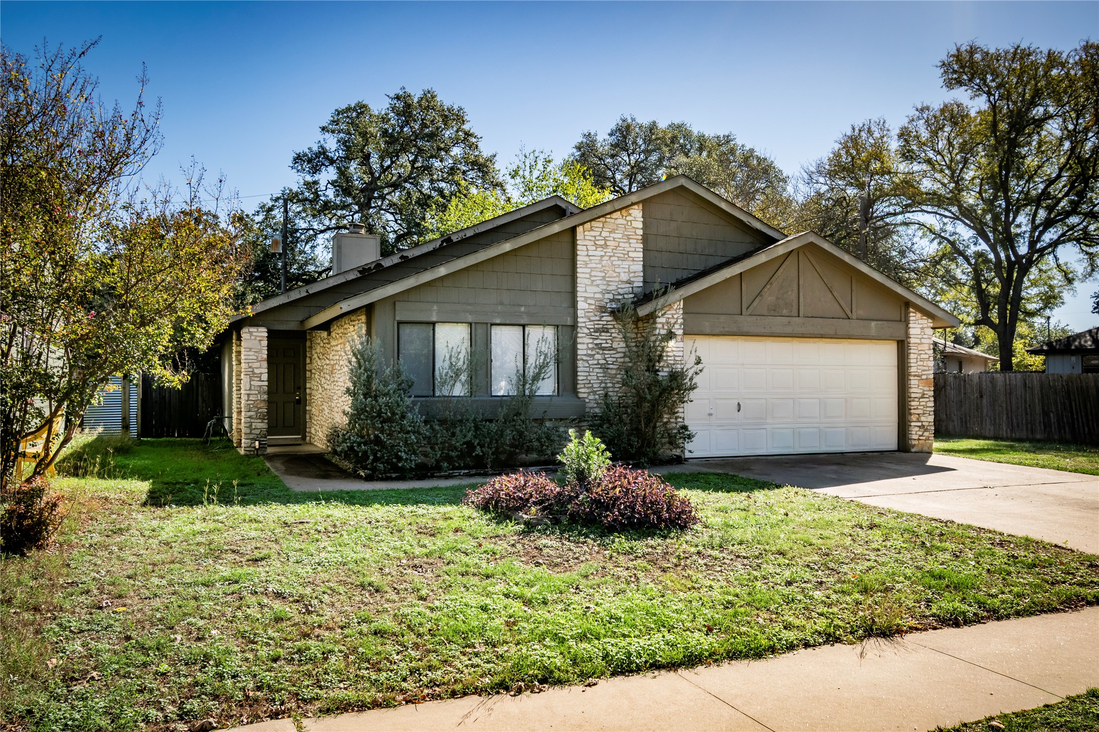 12905 Pegasus Street Austin, TX 78727 - Photo 3 of 32 a front view of a house with a yard and garage