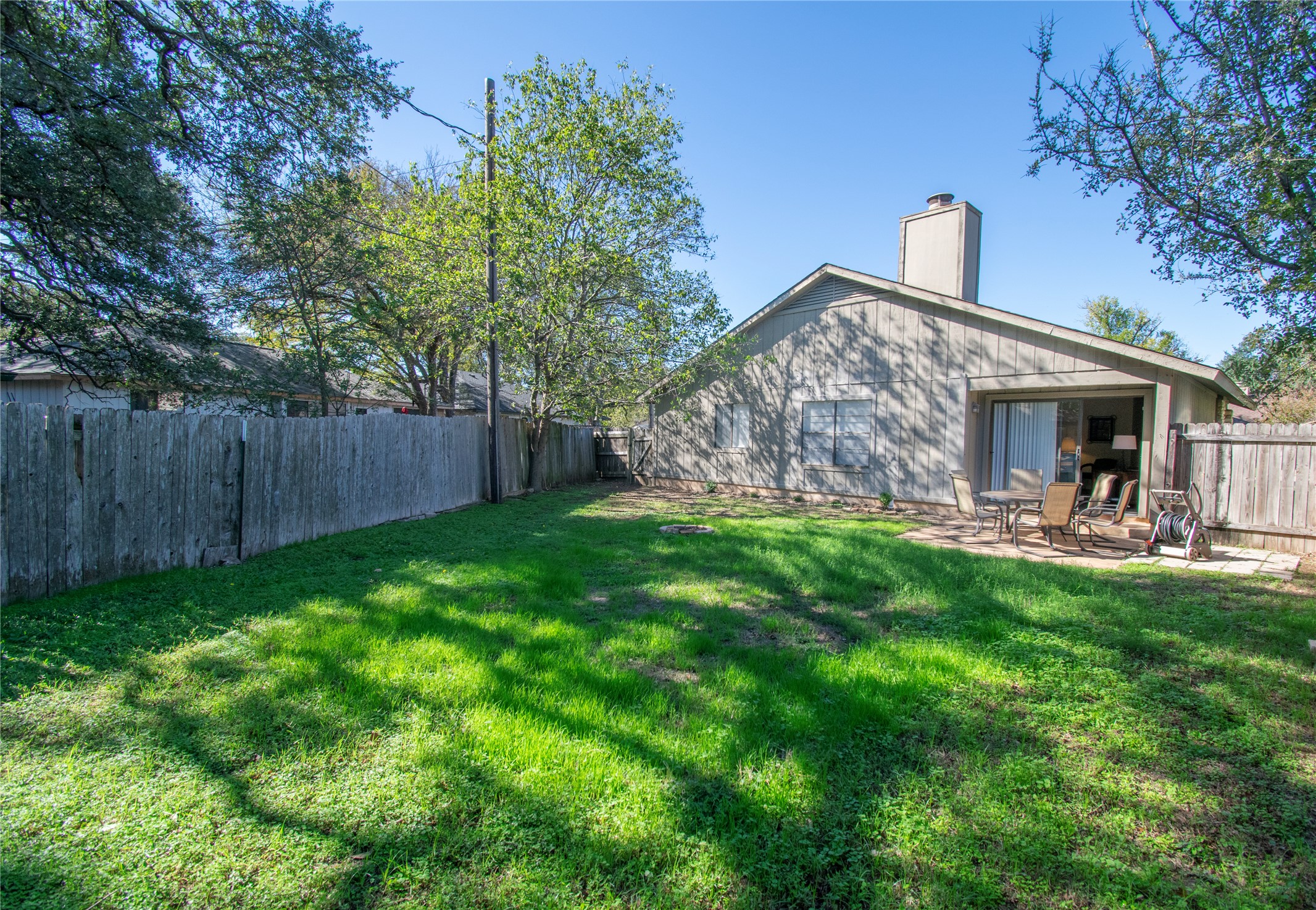 12905 Pegasus Street Austin, TX 78727 - Photo 32 of 32 a view of a house with backyard porch and garden