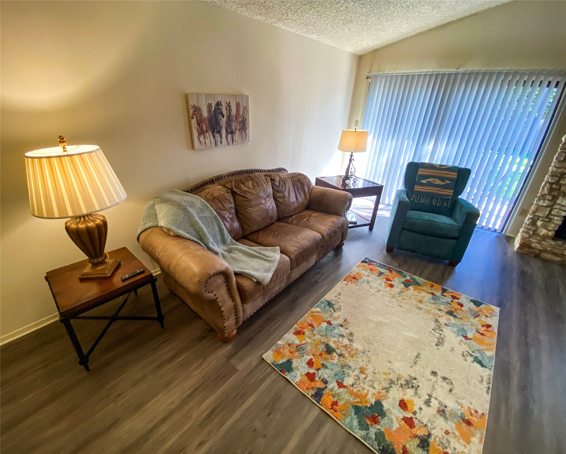 12905 Pegasus Street Austin, TX 78727 - Photo 7 of 32 a living room with a couch and a dresser with wooden floor