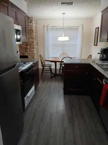 a close view of a refrigerator and a stove in a kitchen