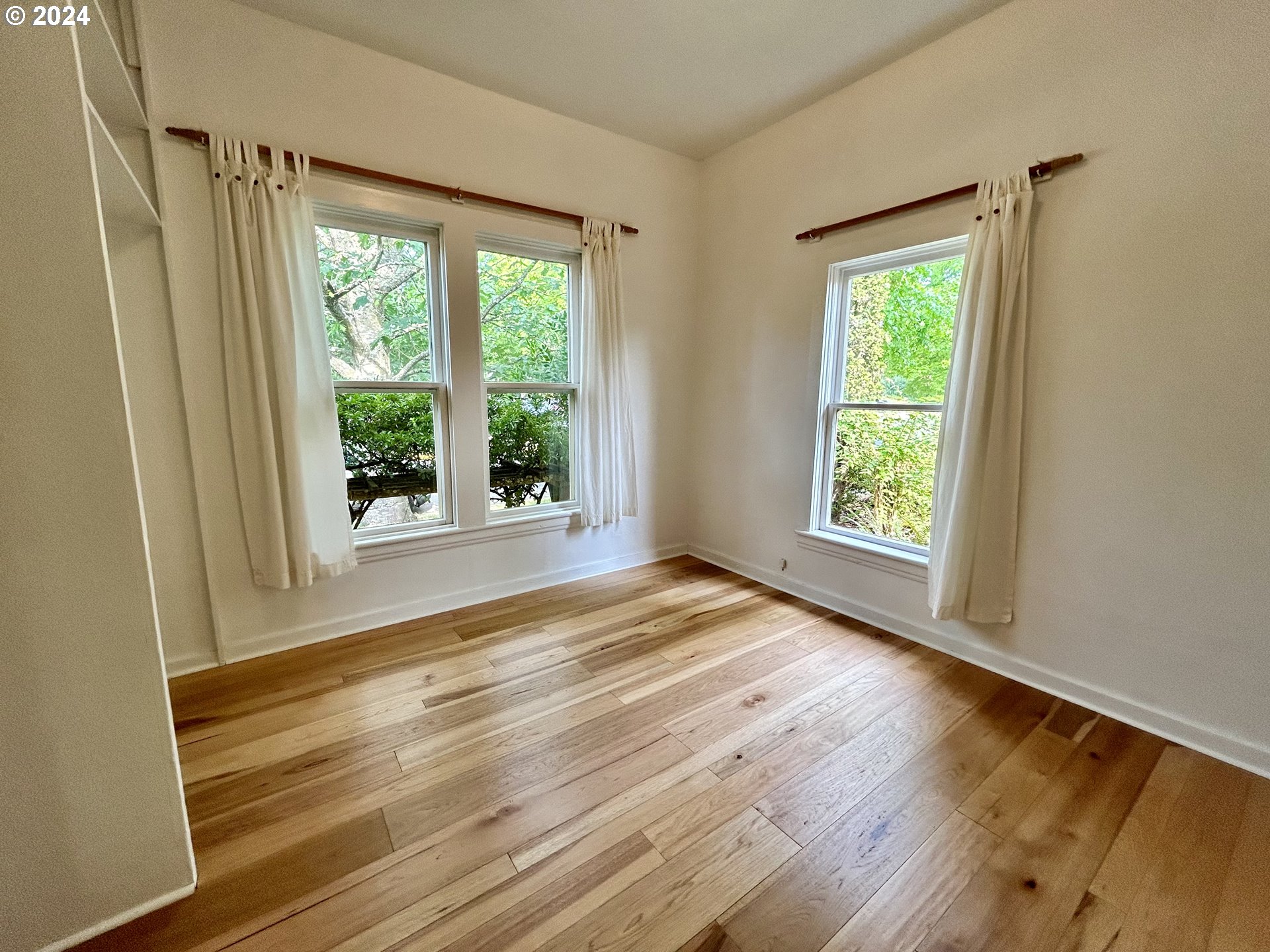 329 5th Street Springfield, OR 97477 - Photo 15 of 35 a view of an empty room with wooden floor and a window