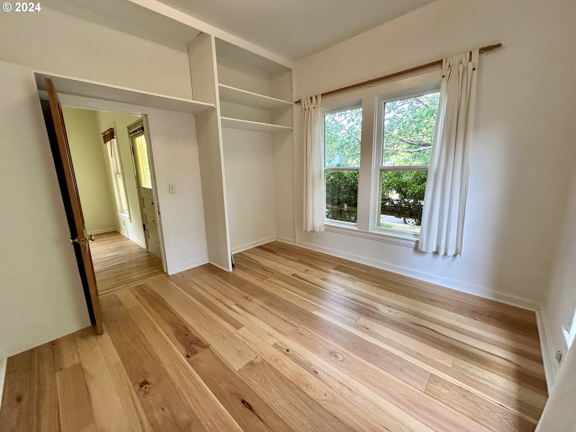 329 5th Street Springfield, OR 97477 - Photo 16 of 35 a view of an empty room with wooden floor and a window