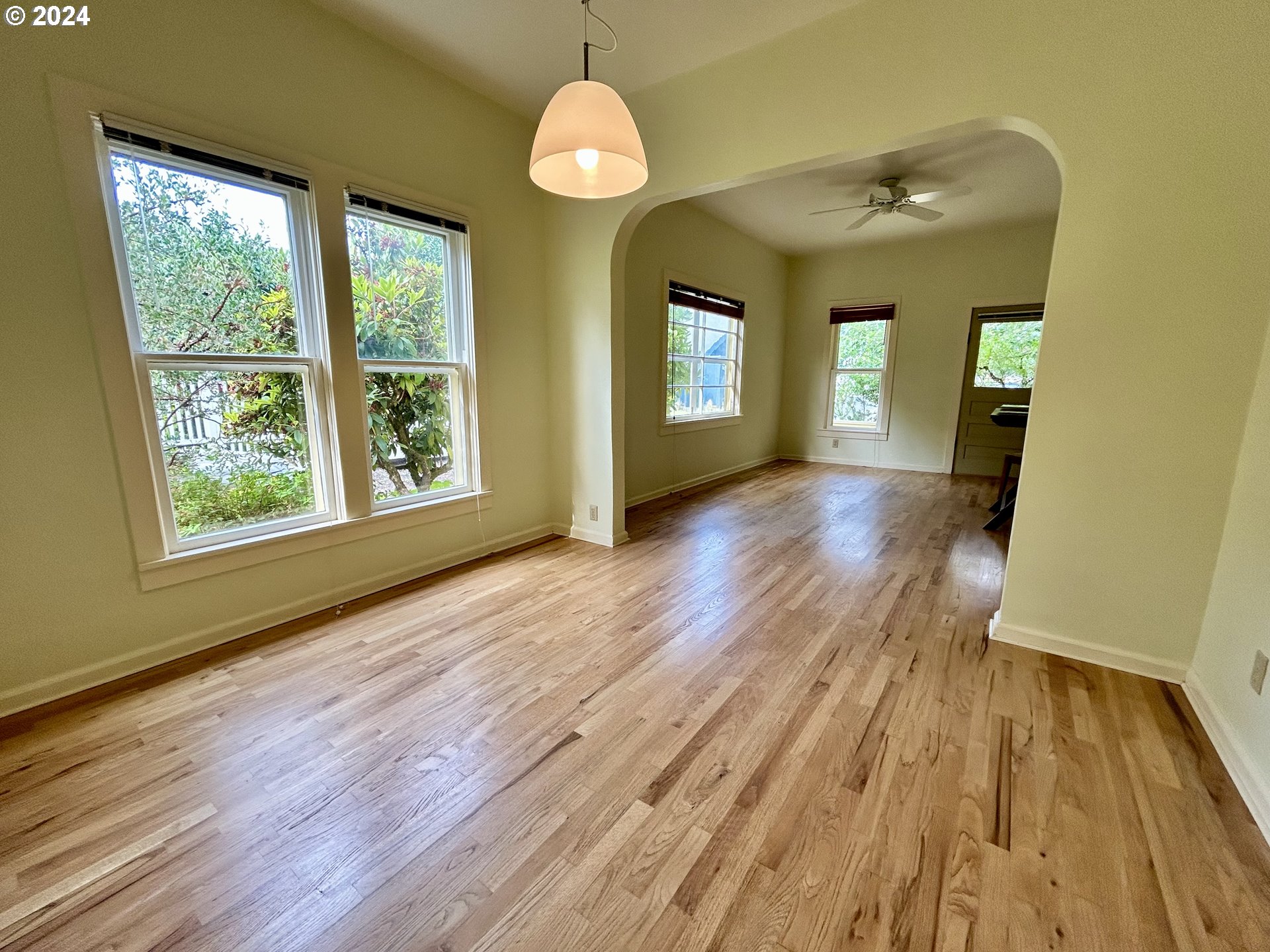 329 5th Street Springfield, OR 97477 - Photo 9 of 35 an empty room with wooden floor and windows