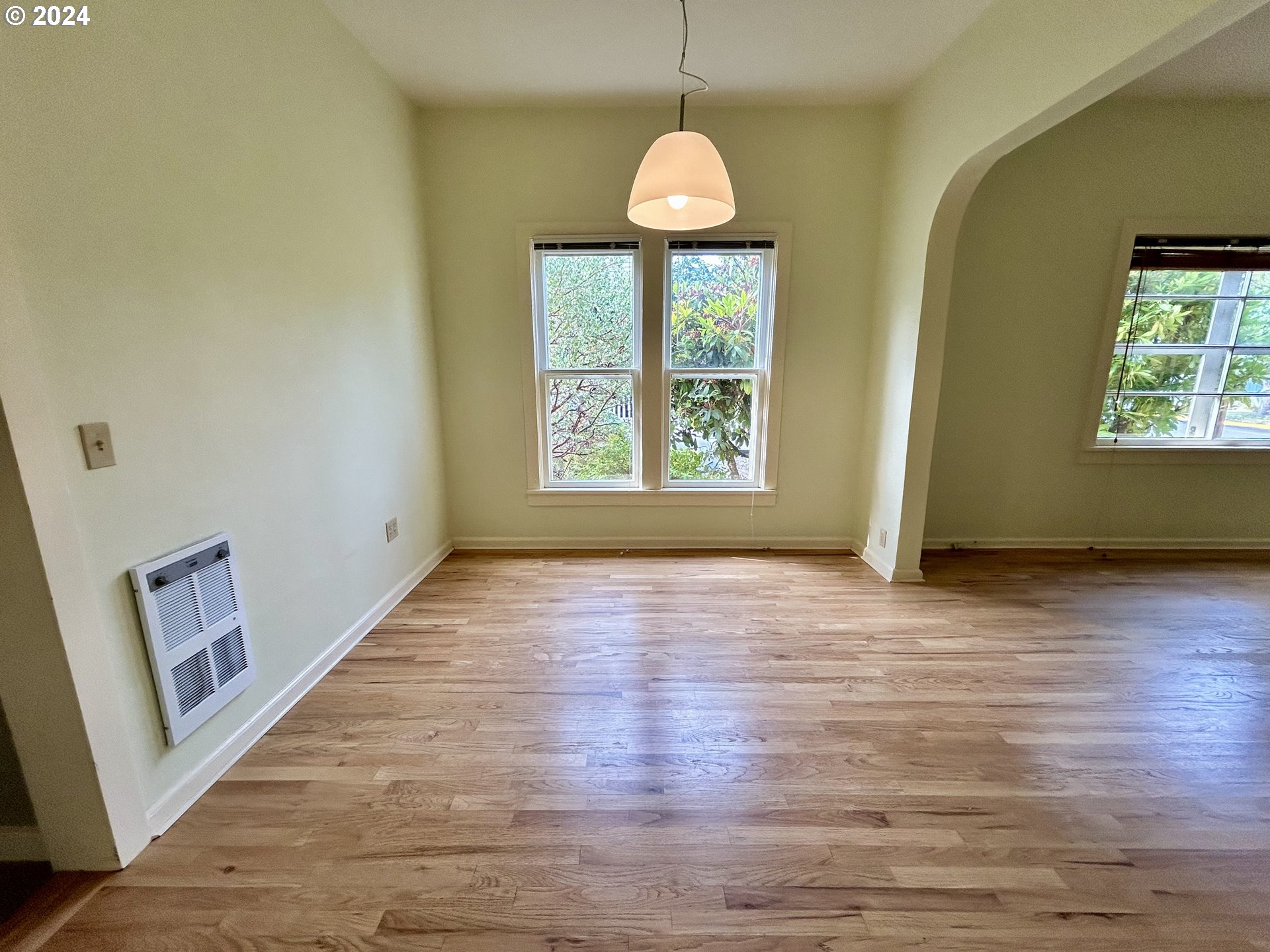 329 5th Street Springfield, OR 97477 - Photo 10 of 35 a view of an empty room with wooden floor and a window