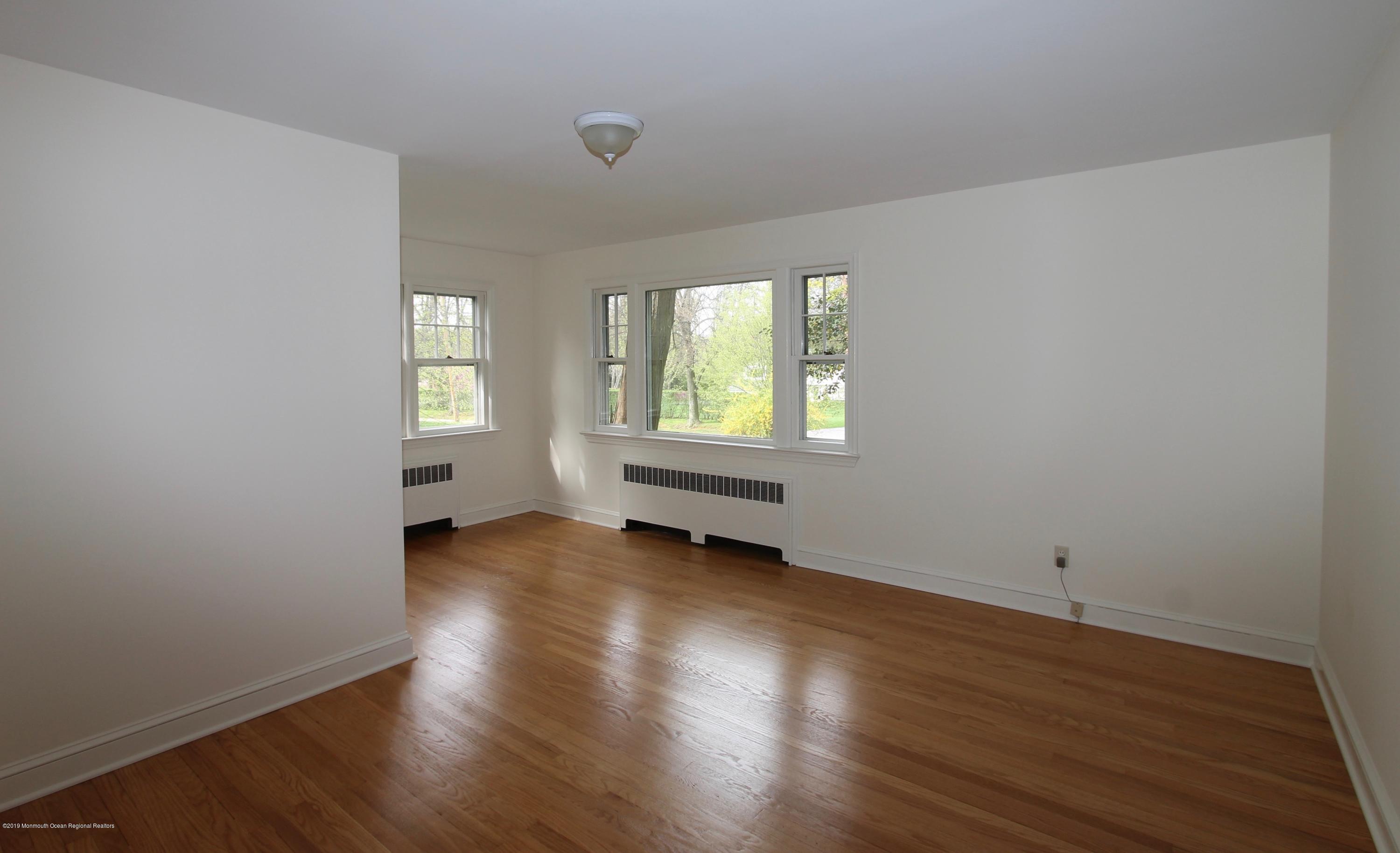 484 Hance Road Little Silver, NJ 07739 - Photo 12 of 22 an empty room with wooden floor and windows