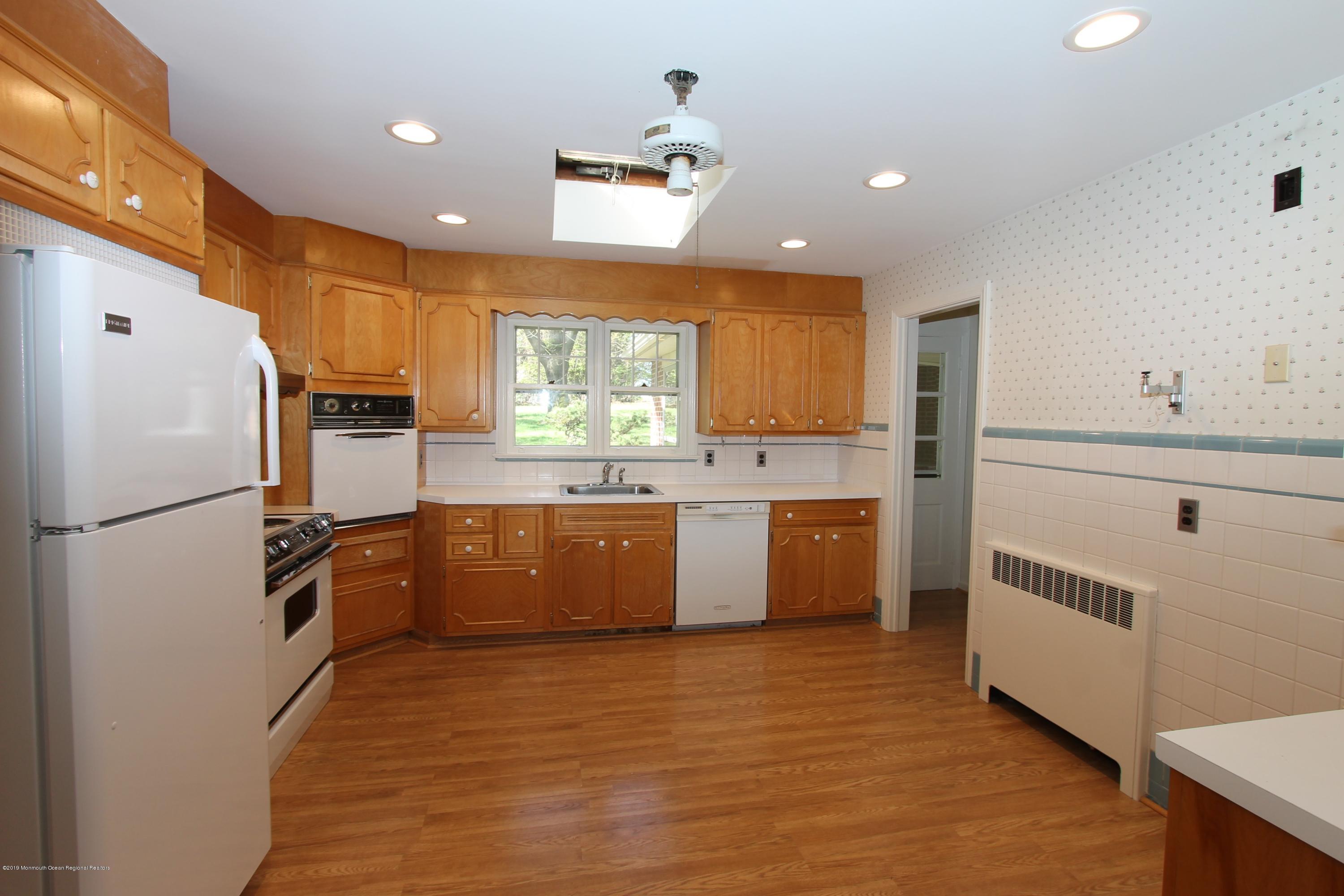484 Hance Road Little Silver, NJ 07739 - Photo 6 of 22 a white kitchen with a sink stainless steel appliances and cabinets