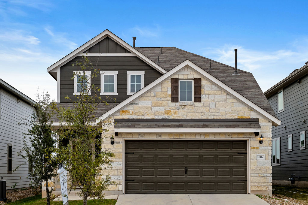 2417 Roosevelt Road Leander, TX 78641 - Photo 1 of 40 View of front of home featuring stone siding, board and batten siding, and driveway