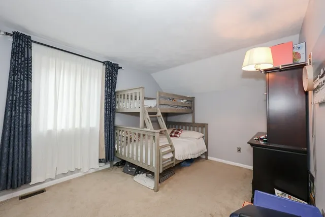 a spacious bedroom with a bed and furniture