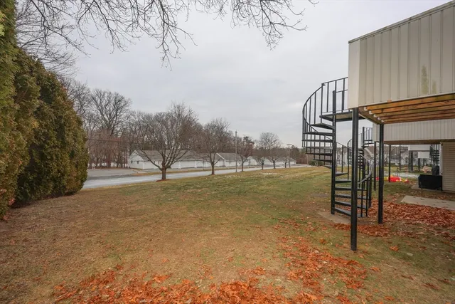 a view of a yard with swimming pool and sitting area