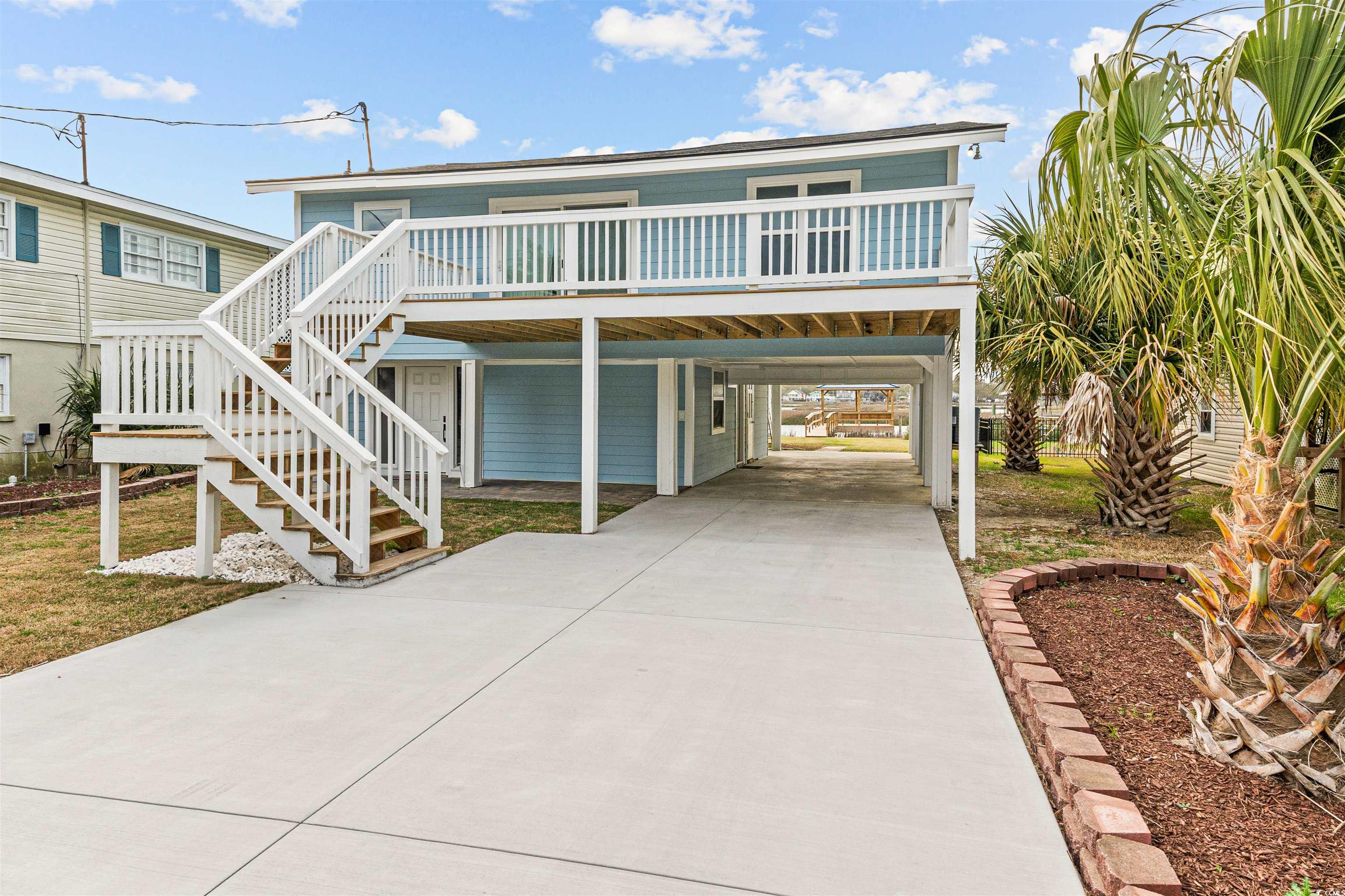 338 State Rd S-26-530 Murrells Inlet, SC 29576 - Photo 12 of 39 Coastal home with stairs, concrete driveway, and a carport