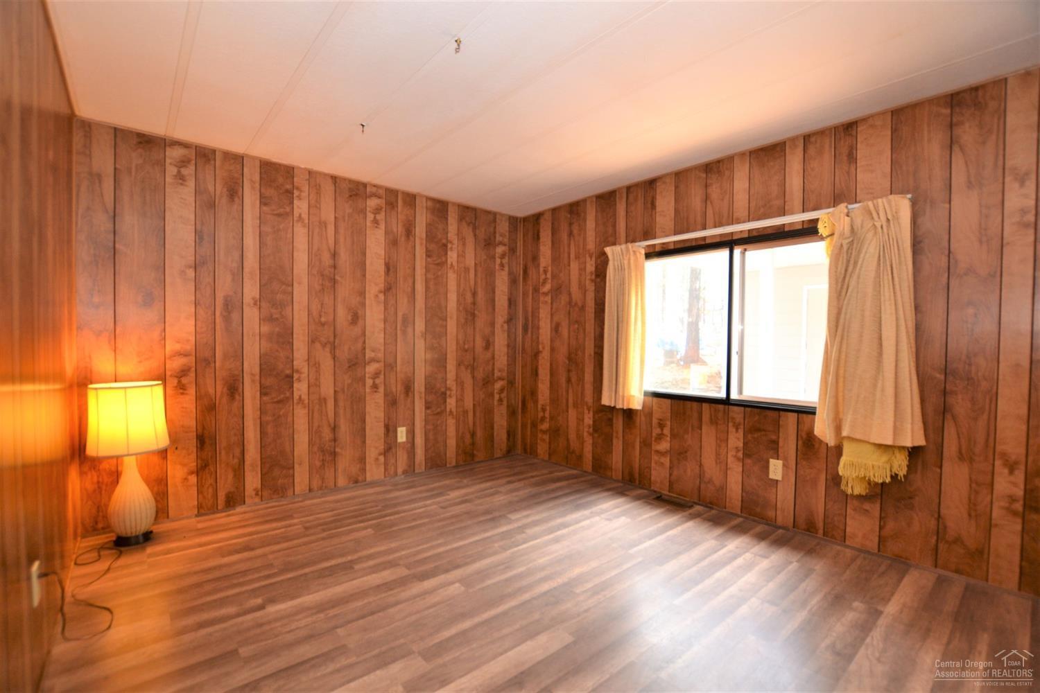 60176 Agate Road Bend, OR 97702 - Photo 17 of 21 a view of an empty room with wooden floor and a window