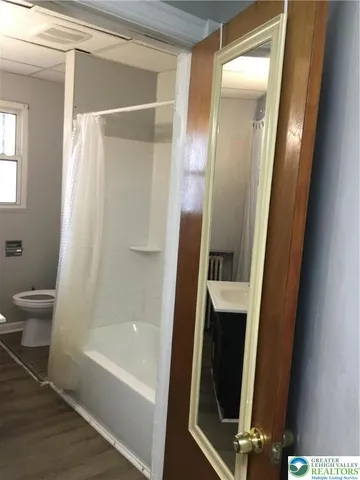 a bathroom with a bathtub a sink and a shower