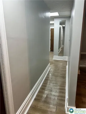 a room with a furniture and a mirror