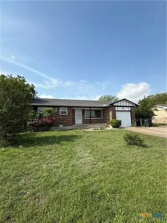 a front view of a house with a yard table and chairs