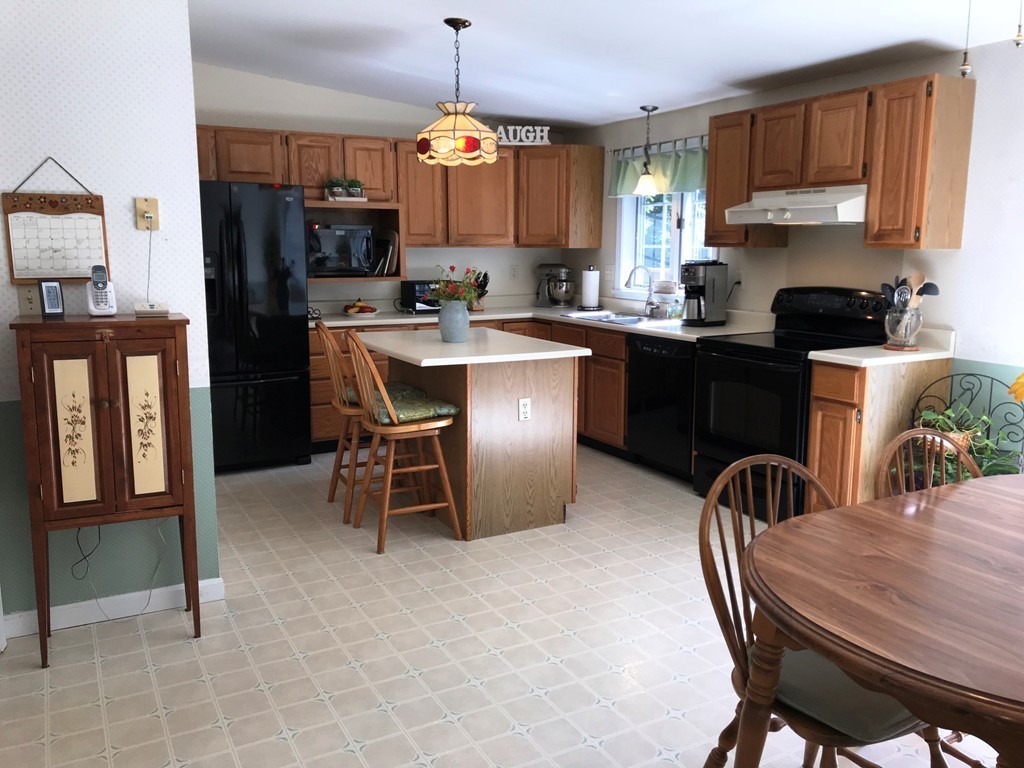 1902 New Sherborn Road Athol, MA 01331 - Photo 4 of 22 a kitchen with a refrigerator a stove a sink and a dining table