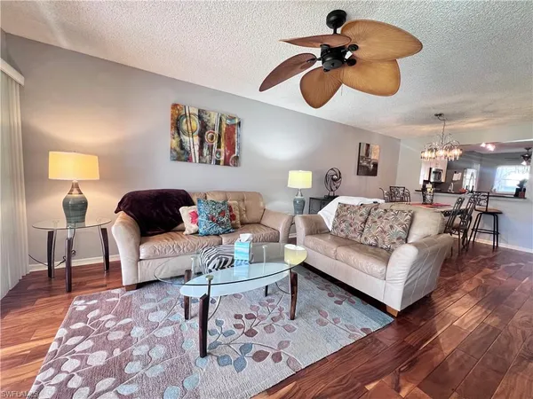 a living room with furniture and a chandelier