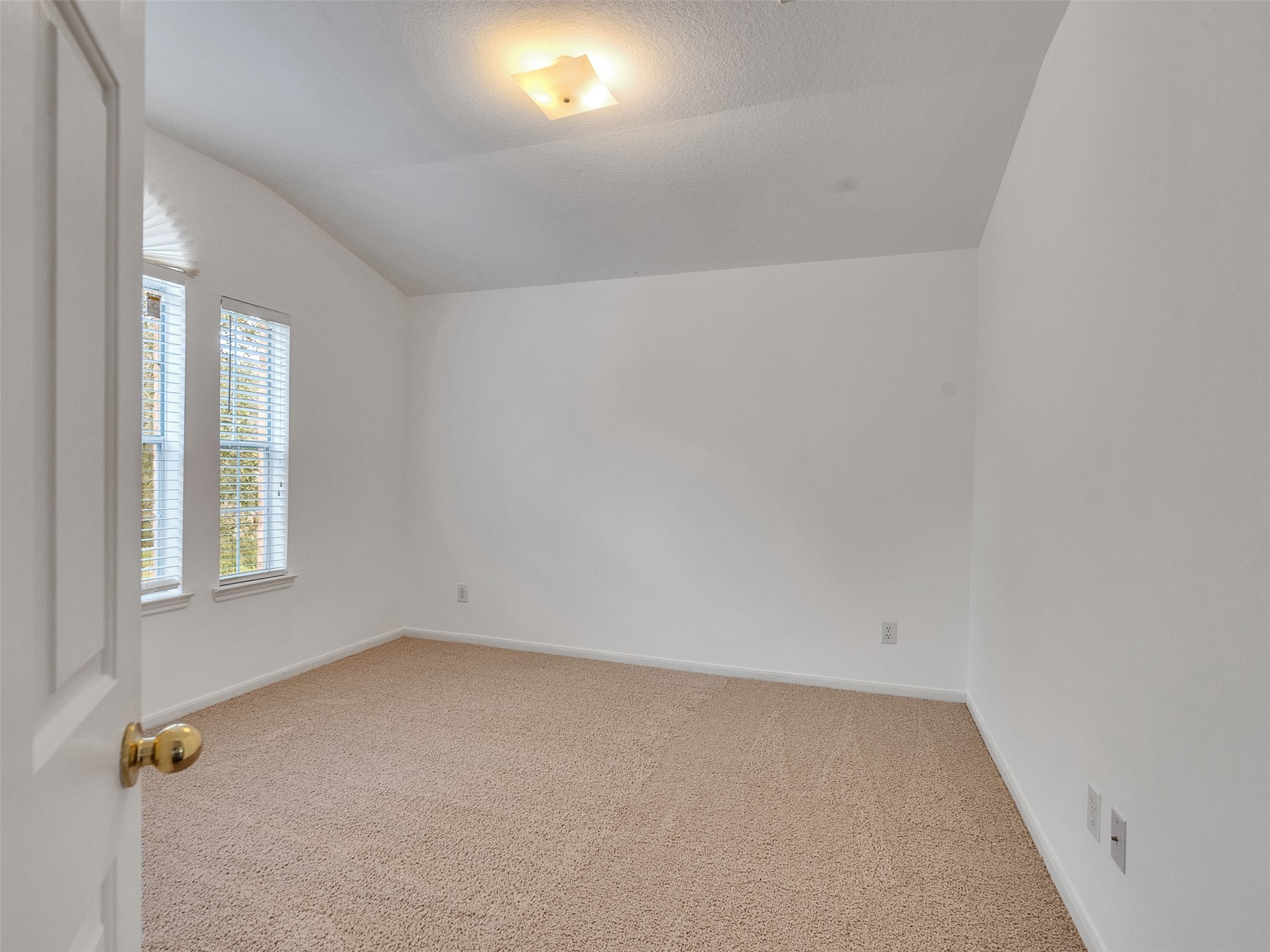 3307 Manor Tree Lane Houston, TX 77068 - Photo 24 of 44 This room features clean white walls, a soft beige carpet, and a ceiling light. It has a window with blinds, offering natural light, and provides a cozy, versatile space.