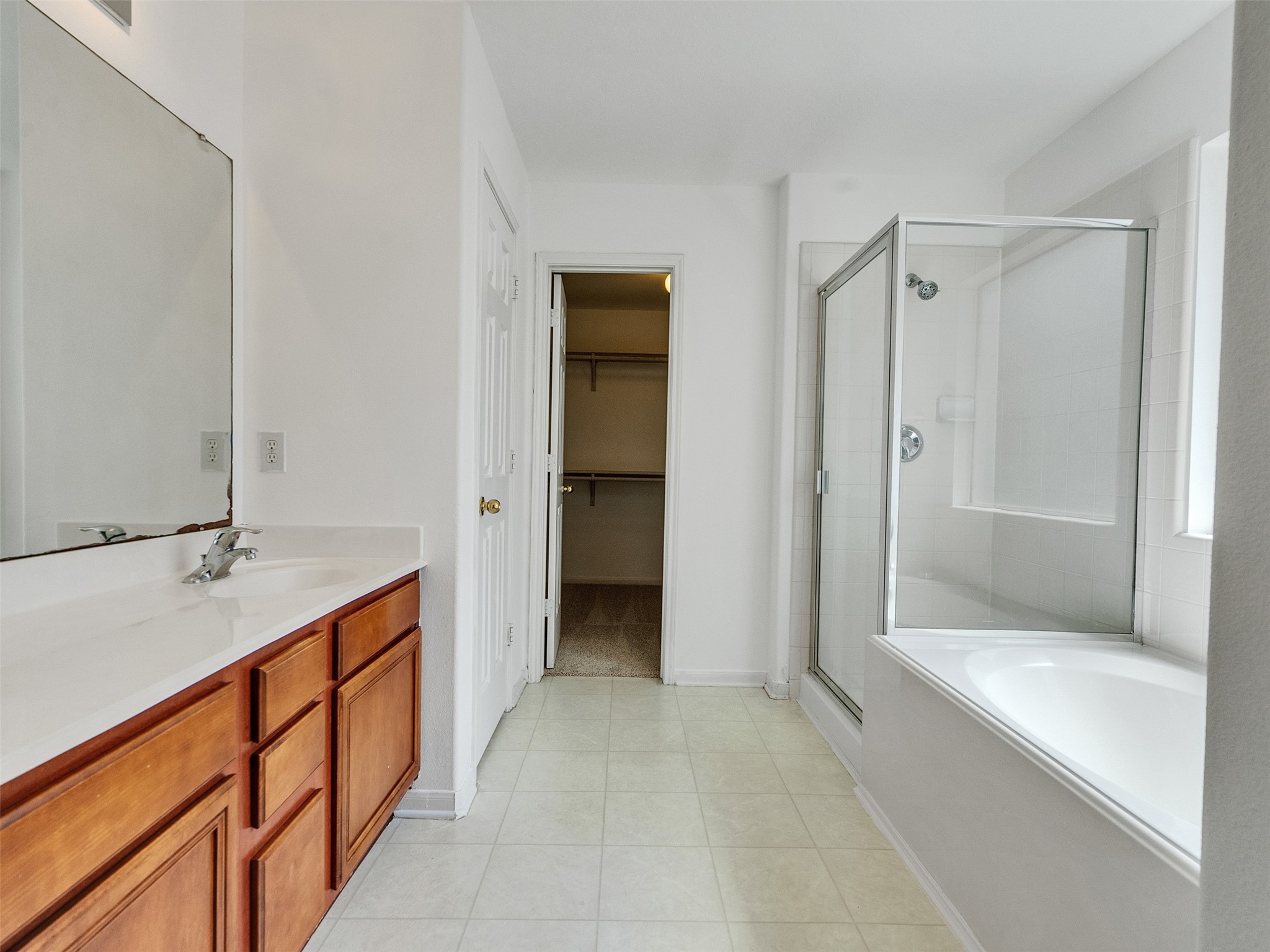 3307 Manor Tree Lane Houston, TX 77068 - Photo 28 of 44 This spacious master bathroom features a large vanity with ample storage, a glass-enclosed shower, and a separate soaking tub. The room is bright with natural light and includes access to a walk-in closet.