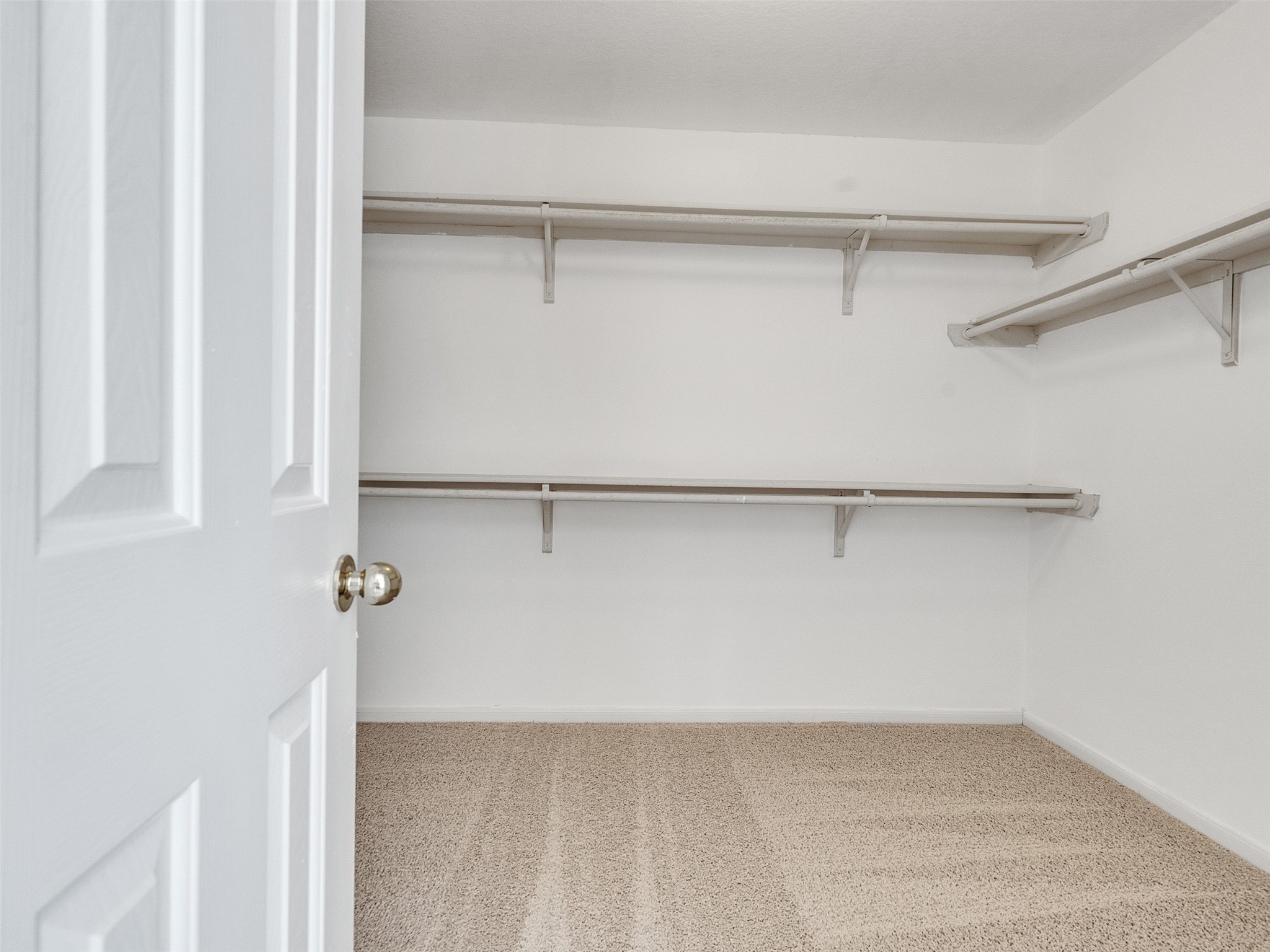 3307 Manor Tree Lane Houston, TX 77068 - Photo 30 of 44 Spacious master walk-in closet with neutral carpeting, white walls, and multiple shelves for organized storage.