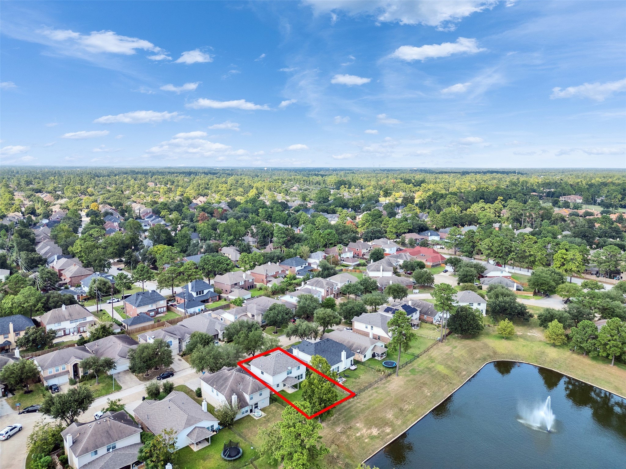 3307 Manor Tree Lane Houston, TX 77068 - Photo 36 of 44 This aerial photo showcases a suburban neighborhood with a highlighted property near a small pond with a fountain. The area is lush with greenery, featuring well-maintained homes that offer a peaceful setting. Great location for families seeking a serene environment.