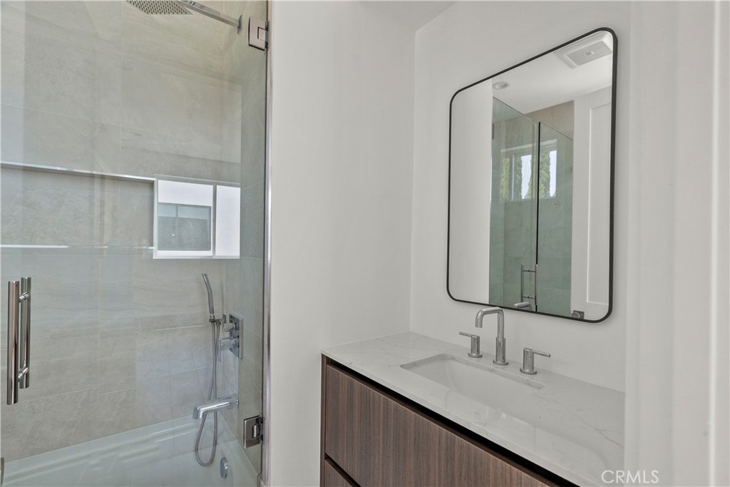 13942 Vanowen Street Van Nuys, CA 91405 - Photo 14 of 21 a bathroom with a sink and a mirror