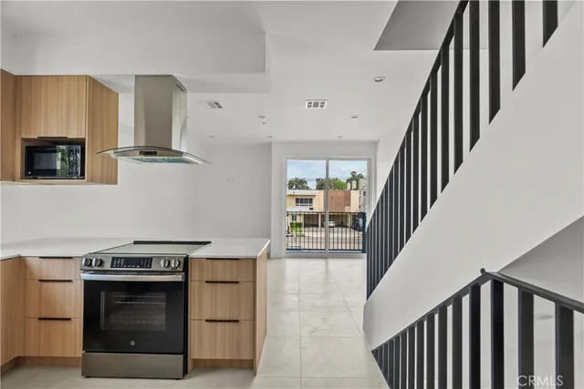 a kitchen with stainless steel appliances granite countertop a stove and a refrigerator