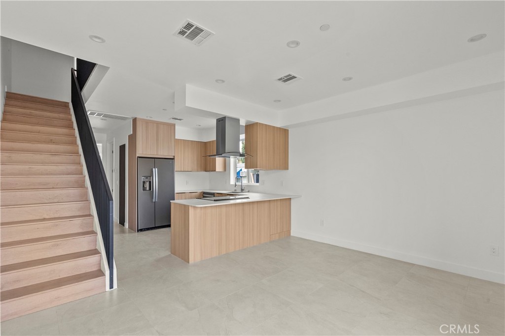 13942 Vanowen Street Van Nuys, CA 91405 - Photo 6 of 21 a kitchen with granite countertop white cabinets and white appliances