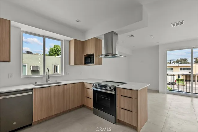 a kitchen that has a sink and a stove