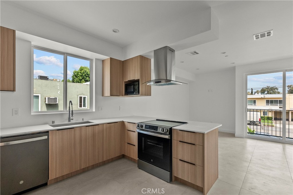 13942 Vanowen Street Van Nuys, CA 91405 - Photo 9 of 21 a kitchen that has a sink and a stove