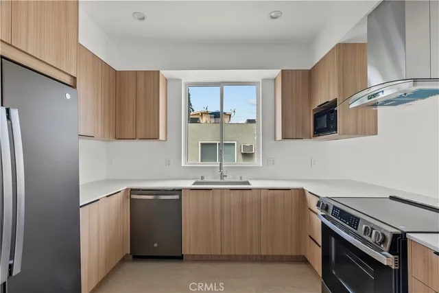 a kitchen with a sink stove and refrigerator