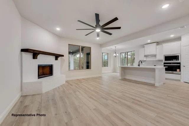 a view of a kitchen with a sink and a fireplace