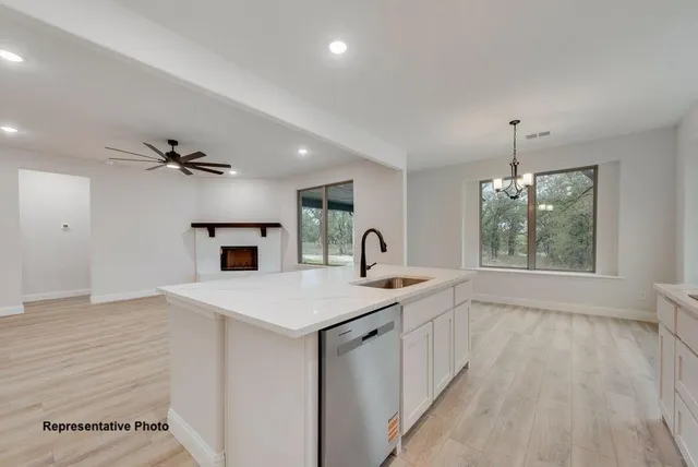 a view of kitchen with sink microwave and refrigerator