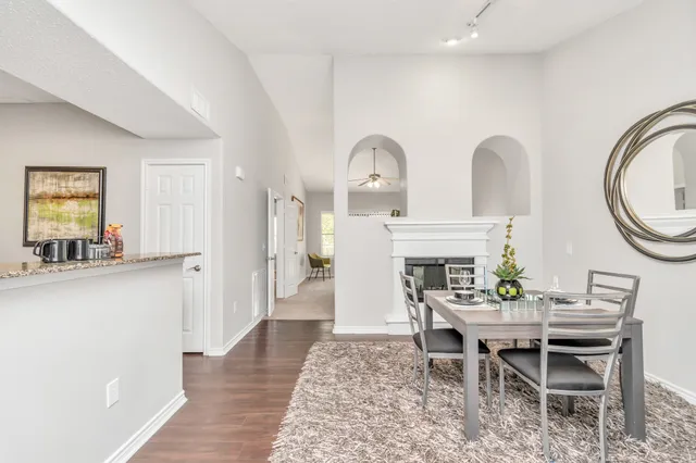 a dining room with furniture and a mirror
