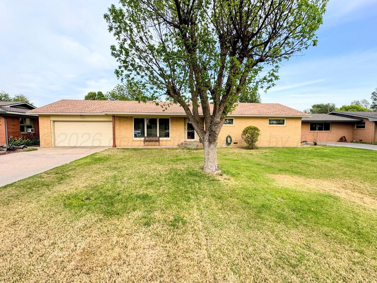 1709 South Eton Street Perryton, TX 79070 - Photo 1 of 22 a white house that has a tree in front of it