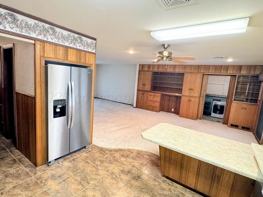 1709 South Eton Street Perryton, TX 79070 - Photo 6 of 22 a view of a kitchen with a sink and a refrigerator