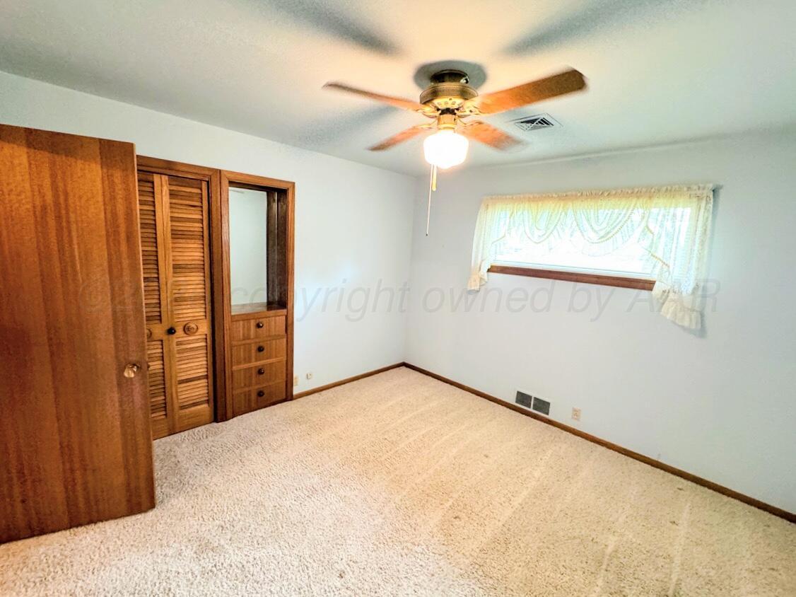 1709 South Eton Street Perryton, TX 79070 - Photo 7 of 22 a view of an empty room with a window