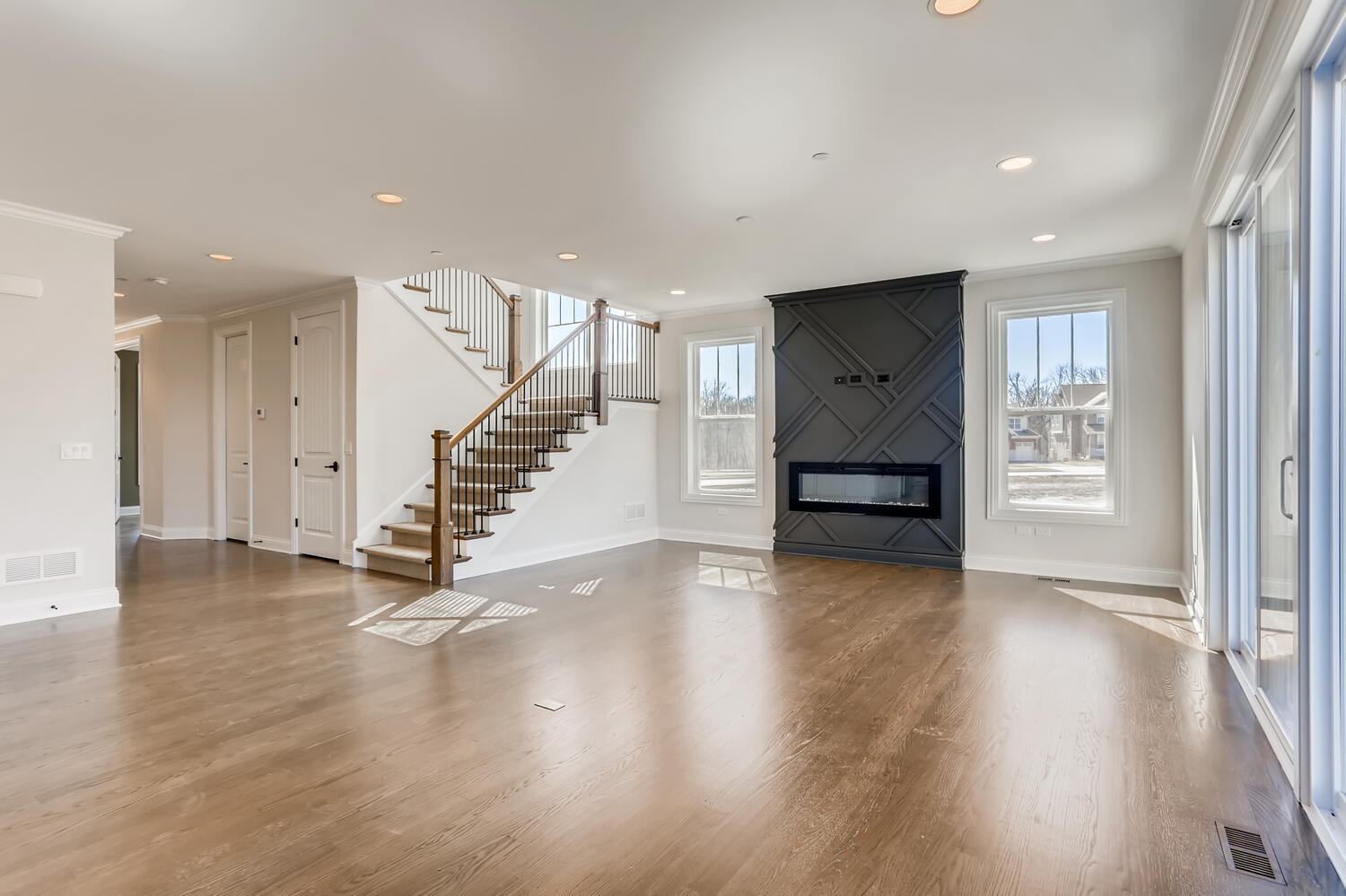 21377 West Sylvan Drive Mundelein, IL 60060 - Photo 4 of 13 a view of an empty room with wooden floor stairs and a living room