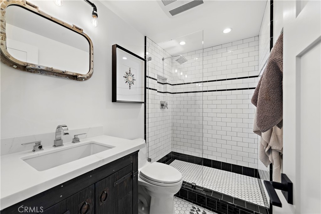 405 Avenida Granada, Unit 312 San Clemente, CA 92672 - Photo 22 of 43 a bathroom with a sink toilet and shower