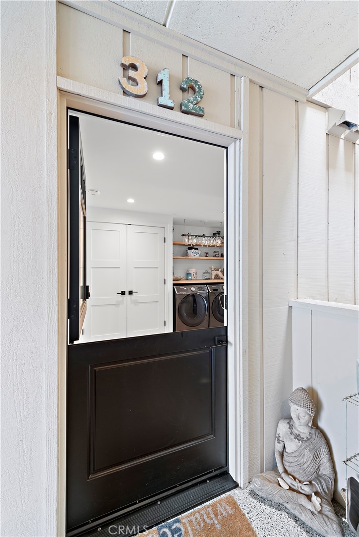 405 Avenida Granada, Unit 312 San Clemente, CA 92672 - Photo 3 of 43 a kitchen with a sink and a mirror