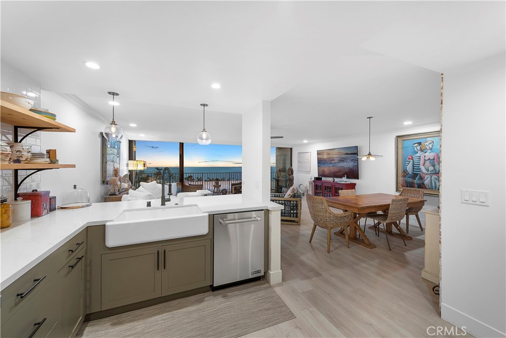 405 Avenida Granada, Unit 312 San Clemente, CA 92672 - Photo 6 of 43 a kitchen with a sink dining table and chairs