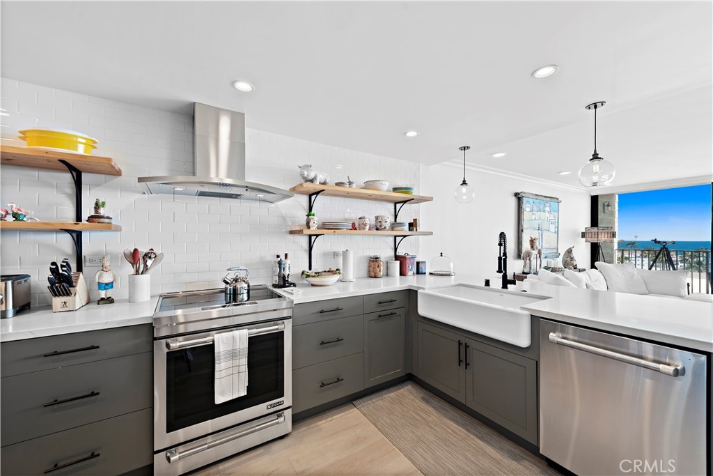 405 Avenida Granada, Unit 312 San Clemente, CA 92672 - Photo 7 of 43 a kitchen with a sink a stove and cabinets