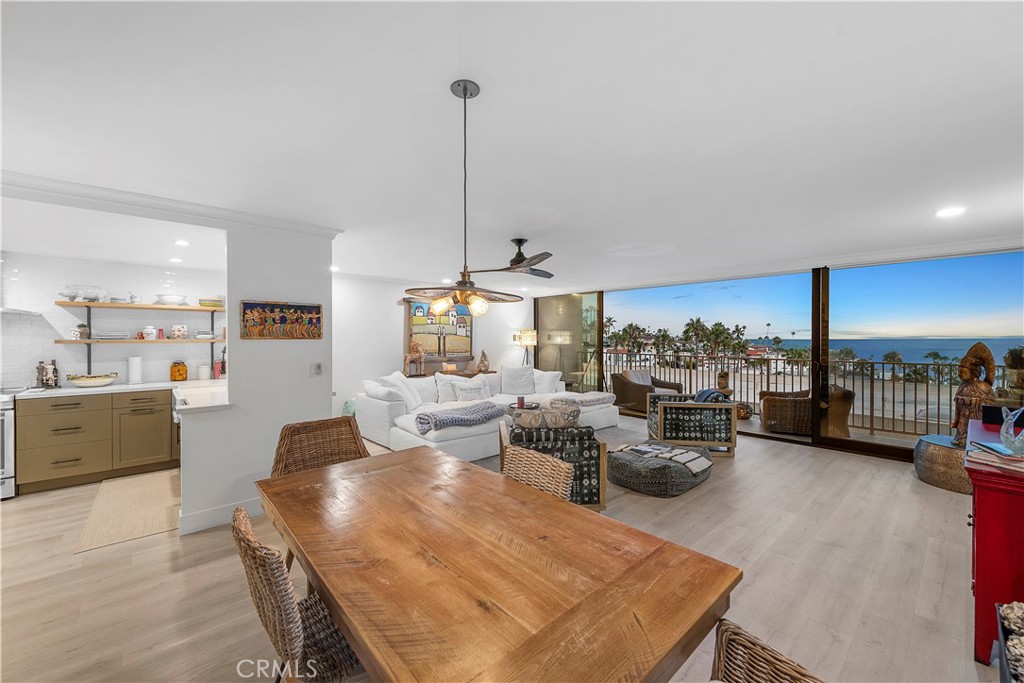 405 Avenida Granada, Unit 312 San Clemente, CA 92672 - Photo 9 of 43 a view of a dining room and livingroom with furniture wooden floor a rug a painting and a chandelier