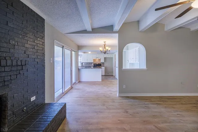 a view of a livingroom with a ceiling fan and a kitchen