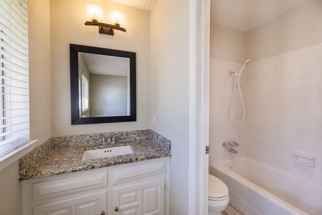 a bathroom with a shower curtain and a sink