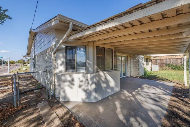 a view of a house with backyard porch and sitting area