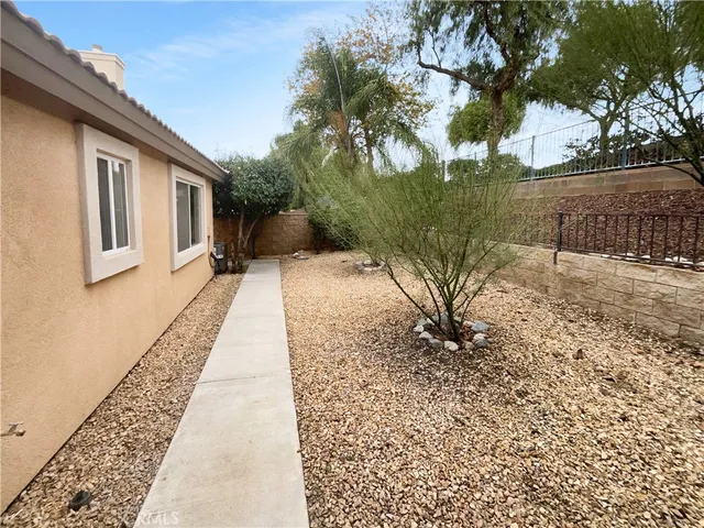 a pathway of a house with a yard