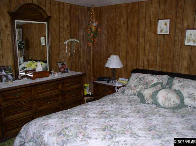 15075 Rhyolite Circle Reno, NV 89521 - Photo 5 of 9 a bedroom with a bed and a dresser