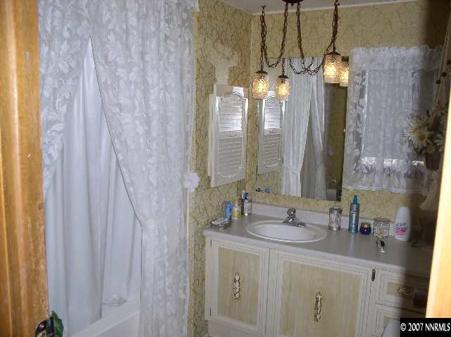 15075 Rhyolite Circle Reno, NV 89521 - Photo 6 of 9 a bathroom with a double vanity sink and a mirror