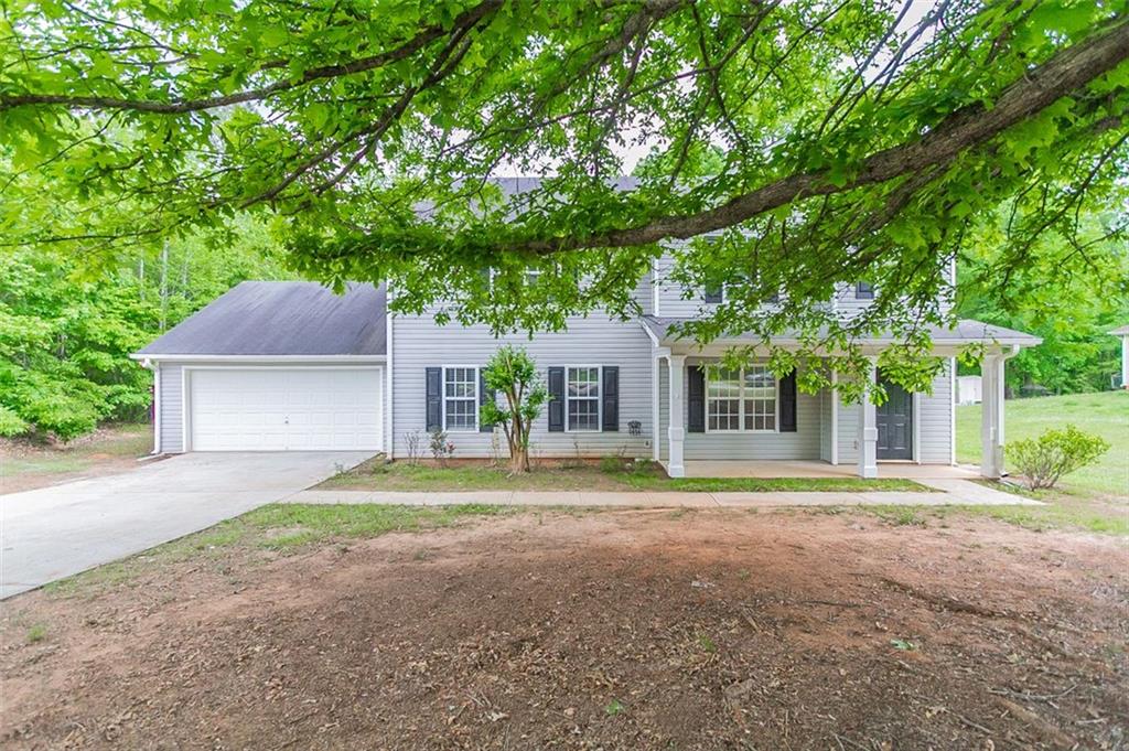 90 Aspen Drive Covington, GA 30016 - Photo 1 of 1 a front view of a house with a yard and trees