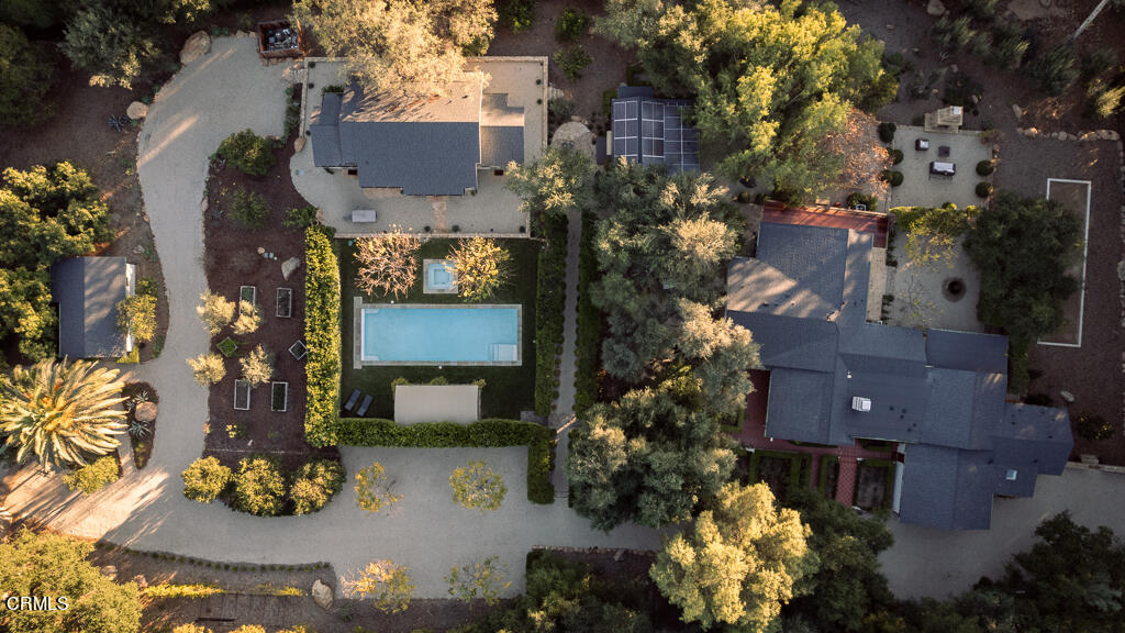 an aerial view of a house with a yard and a fountain